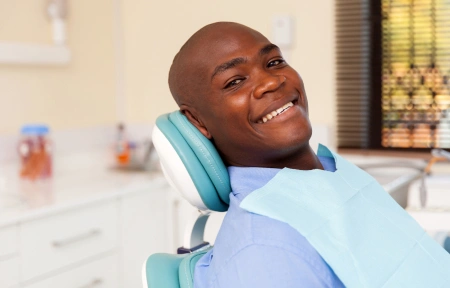Smiling patient relaxing in a dental chair