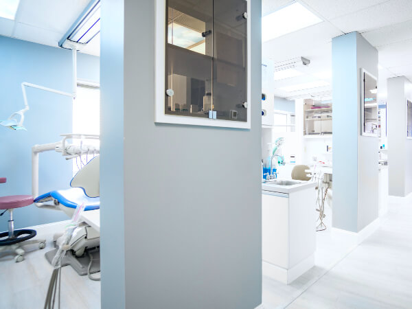 Modern dental treatment room with dental chair and equipment