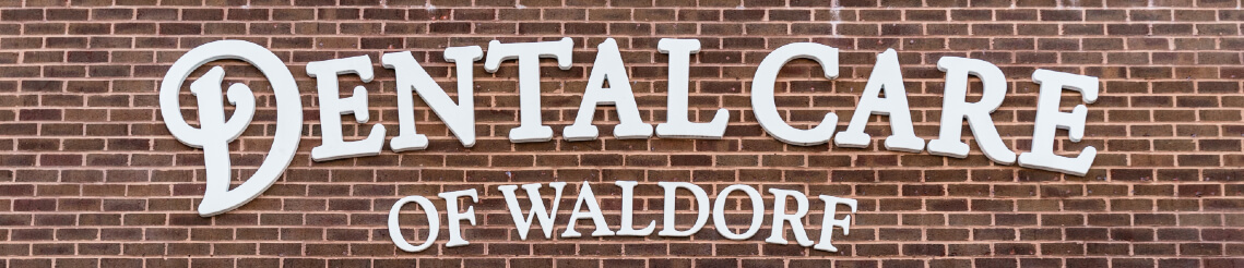 dental care of Waldorf logo on wall